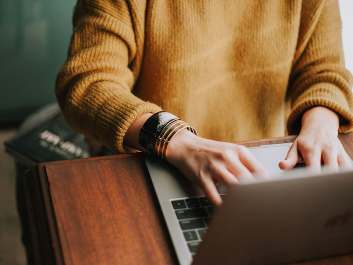 A woman typing on her laptop.